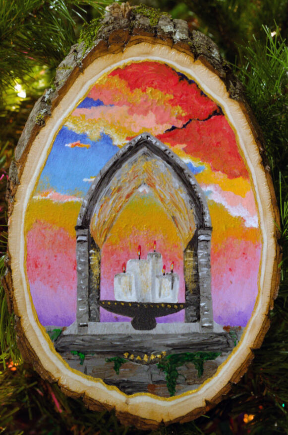 A painting of a stone shrine against a colorful sunset, insides lit by white candles.